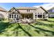 Expansive backyard view highlighting the patio, lush lawn, and well-appointed outdoor living space at 705 Vintage Creek Dr, Matthews, NC 28104