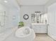 Bright bathroom featuring a soaking tub, glass shower, and white cabinets at 705 Vintage Creek Dr, Matthews, NC 28104