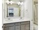 Well-lit bathroom featuring double sinks and vanity with shower and toilet at 705 Vintage Creek Dr, Matthews, NC 28104