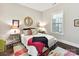 Bright bedroom with hardwood floors, neutral walls, a colorful rug and ensuite bathroom at 705 Vintage Creek Dr, Matthews, NC 28104