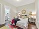 Cozy bedroom with hardwood floors, an ensuite bathroom, and a colorful rug at 705 Vintage Creek Dr, Matthews, NC 28104
