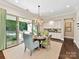 Cozy dining area featuring a chandelier and sliding glass doors to the outdoor patio at 705 Vintage Creek Dr, Matthews, NC 28104