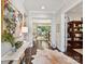 Grand foyer with hardwood floors, bright lighting, and a glimpse into the living and dining areas at 705 Vintage Creek Dr, Matthews, NC 28104