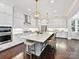 Bright, expansive kitchen with white cabinetry, pendant lighting, and a large central island with seating at 705 Vintage Creek Dr, Matthews, NC 28104