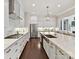 Bright kitchen with stainless steel appliances, white cabinets, and a long island perfect for dining and meal prep at 705 Vintage Creek Dr, Matthews, NC 28104