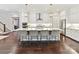 Spacious kitchen with white cabinets, stainless steel appliances, and an island with seating for four at 705 Vintage Creek Dr, Matthews, NC 28104