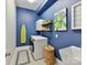 Laundry room features modern appliances, blue walls, and stylish decor at 705 Vintage Creek Dr, Matthews, NC 28104