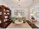 Inviting living room features built-in bookcases, comfortable seating, and natural light from a large window at 705 Vintage Creek Dr, Matthews, NC 28104