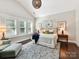Inviting main bedroom with large windows, neutral tones, and a stylish blue area rug at 705 Vintage Creek Dr, Matthews, NC 28104