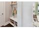 Mudroom with custom shelving, hooks, a bench, and access to the hallway at 705 Vintage Creek Dr, Matthews, NC 28104