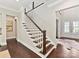 Elegant staircase with dark hardwood steps and white risers leading to the upper level at 705 Vintage Creek Dr, Matthews, NC 28104