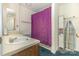 Bathroom featuring a sink, a toilet behind a purple shower curtain and storage shelves at 7304 Pebblestone Dr, Charlotte, NC 28212