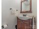 Powder room with wood vanity and bronze fixtures, perfect for guests at 7304 Pebblestone Dr, Charlotte, NC 28212