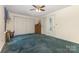 This bedroom features a ceiling fan, large closet, and carpeting at 7304 Pebblestone Dr, Charlotte, NC 28212