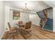 Dining room with wood floors, chandelier, and view into the kitchen at 7304 Pebblestone Dr, Charlotte, NC 28212