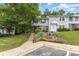 Delightful home featuring a meticulously maintained lawn, mature trees, and a warm, inviting facade at 7304 Pebblestone Dr, Charlotte, NC 28212