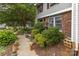 Exterior of home showing the surrounding landscape with flowers and shady trees for comfortable outdoor living at 7304 Pebblestone Dr, Charlotte, NC 28212