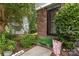 Brick front entrance with a green bushes and a decorative sign at 7304 Pebblestone Dr, Charlotte, NC 28212