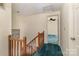 Upstairs hallway leading to bedrooms with carpeted floors at 7304 Pebblestone Dr, Charlotte, NC 28212