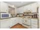 Efficient kitchen with white appliances, granite countertops, and wood floor at 7304 Pebblestone Dr, Charlotte, NC 28212