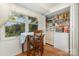 Kitchen area with small dining table, window, and walk-in pantry with shelving at 7304 Pebblestone Dr, Charlotte, NC 28212
