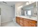 Bathroom features a double sink vanity with framed mirror and tiled flooring at 7930 Kelburn Ln, Charlotte, NC 28273
