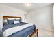 Bedroom featuring carpet flooring, neutral walls, and a dark wood bed frame at 7930 Kelburn Ln, Charlotte, NC 28273