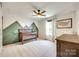 Bedroom featuring carpet, a dark wooden crib, and green mountain accent wall at 7930 Kelburn Ln, Charlotte, NC 28273