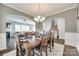 Open-concept dining area with hardwood floors, arched doorways, and seamless access to the living area at 7930 Kelburn Ln, Charlotte, NC 28273