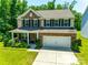 Inviting two-story home with brick accents, a covered front porch, a well-kept lawn, and an attached two-car garage at 7930 Kelburn Ln, Charlotte, NC 28273