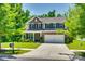 Charming two-story home with a brick facade, well-maintained lawn, mature trees, and an attached two-car garage at 7930 Kelburn Ln, Charlotte, NC 28273