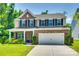 Charming two-story home featuring a brick facade, attached two-car garage, and well-manicured lawn at 7930 Kelburn Ln, Charlotte, NC 28273