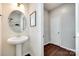 Neat half bathroom with modern fixtures, pedestal sink, and tile flooring at 7930 Kelburn Ln, Charlotte, NC 28273