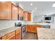 A kitchen with wood cabinets, stainless appliances, and granite countertops at 7930 Kelburn Ln, Charlotte, NC 28273