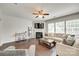 Spacious living room with hardwood floors, fireplace, and lots of natural light at 7930 Kelburn Ln, Charlotte, NC 28273