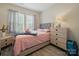 Cozy bedroom with soft pinks and grays featuring two windows and luxury vinyl plank flooring at 900 4Th St, Spencer, NC 28159