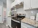 A kitchen with granite countertops, a stylish backsplash, and modern appliances at 900 4Th St, Spencer, NC 28159