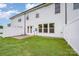 Backyard featuring a well-maintained lawn, a small patio, and a privacy fence at 9009 Odell Corners Nw Blvd, Concord, NC 28027