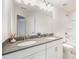 Bathroom with double sinks, gray countertop, and a large mirror at 9009 Odell Corners Nw Blvd, Concord, NC 28027