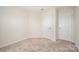 Bedroom with carpet flooring and 2 white doors on the wall at 9009 Odell Corners Nw Blvd, Concord, NC 28027
