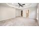 Large bedroom boasts plush carpeting, a ceiling fan, and a walk-in closet for ample storage at 9009 Odell Corners Nw Blvd, Concord, NC 28027