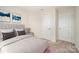 Relaxing bedroom with soft carpet, a cozy bed, and modern artwork at 9009 Odell Corners Nw Blvd, Concord, NC 28027
