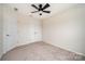Bedroom with ceiling fan, carpet flooring, and double door closet at 9009 Odell Corners Nw Blvd, Concord, NC 28027