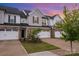 Charming townhome with brick accents, white siding, and attached garages with ample parking at 9009 Odell Corners Nw Blvd, Concord, NC 28027