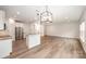 Open floor plan with modern kitchen and stainless steel appliances, seamlessly connected to living area at 9009 Odell Corners Nw Blvd, Concord, NC 28027
