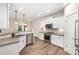 Modern kitchen with stainless steel appliances, gray countertops, and wood flooring at 9009 Odell Corners Nw Blvd, Concord, NC 28027