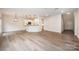 Bright open-concept living space with hardwood floors, modern lighting, and neutral colors at 9009 Odell Corners Nw Blvd, Concord, NC 28027