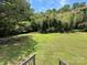 Expansive backyard features dense vegetation and lush green grass at 9044 Forington Ln, Gastonia, NC 28056