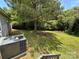 Spacious backyard boasts mature trees and lush grass for outdoor enjoyment at 9044 Forington Ln, Gastonia, NC 28056