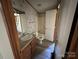 Traditional bathroom features a vanity sink, wood cabinets, and tiled shower at 9044 Forington Ln, Gastonia, NC 28056